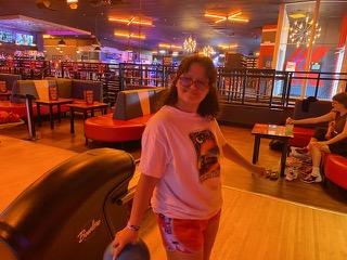 Student with a bowling ball in front of the lobby