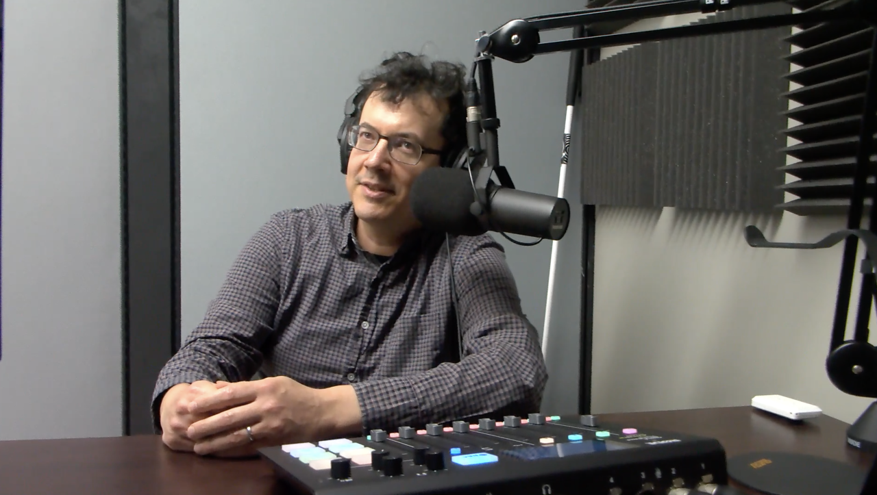 Andrew Leland seated by recording equipment