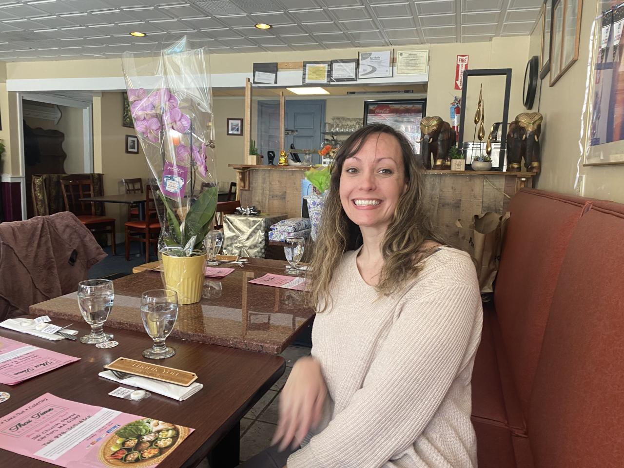 Cal Butler smiling and sitting in a booth at Thai Time restaurant