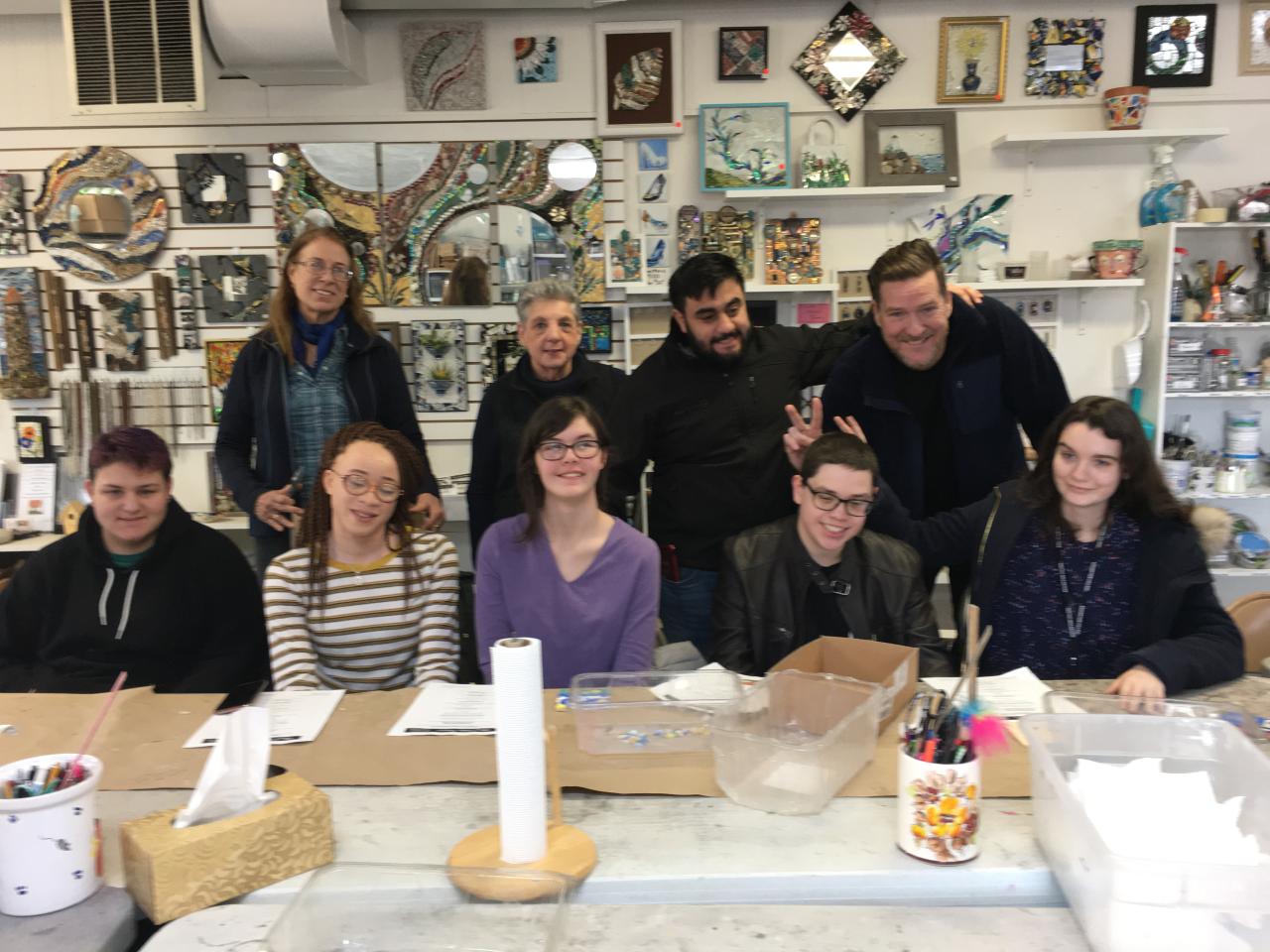 group of students finishing up their mosaic projects at an artist's studio.