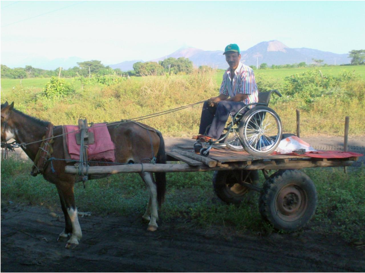 man in wheelchair on the back of a mule-drawn carriage in Nicaragua (photo by Stephen Petegorsky)