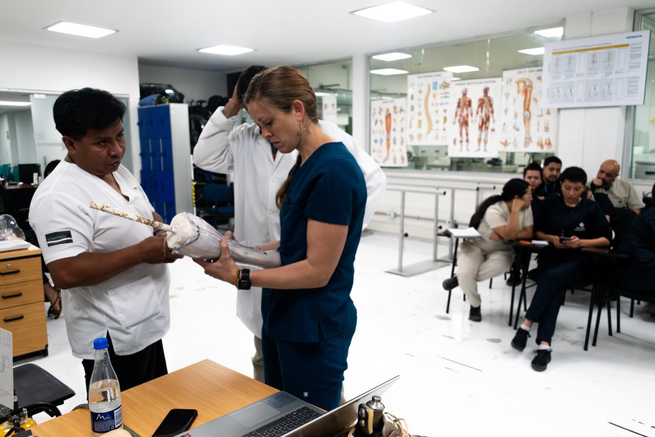 Two prosthetic technicians in Colombia examining a new prosthetic device.