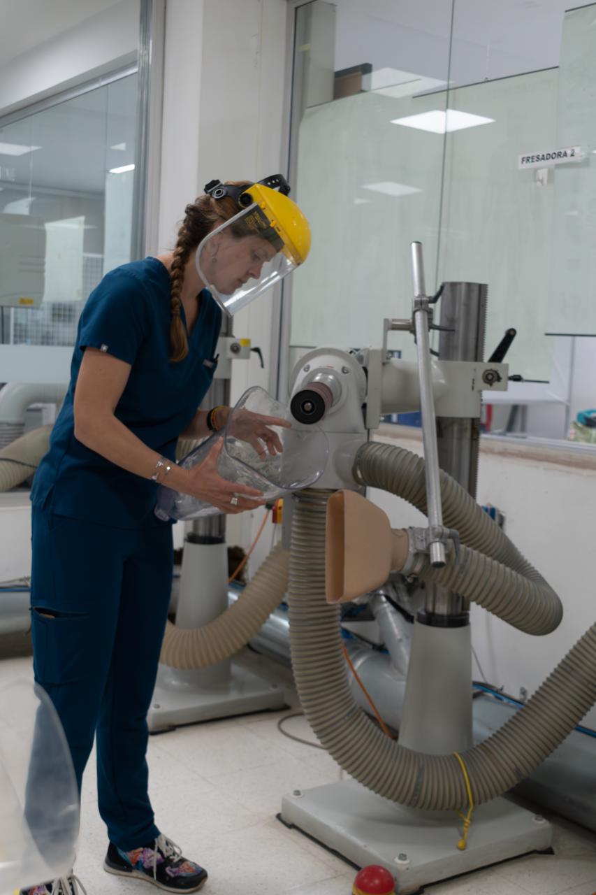 Polus Center Board President and Certified Prosthetist, Nellie Zarif, building an artificial leg in Colombian prosthetic clinic. 