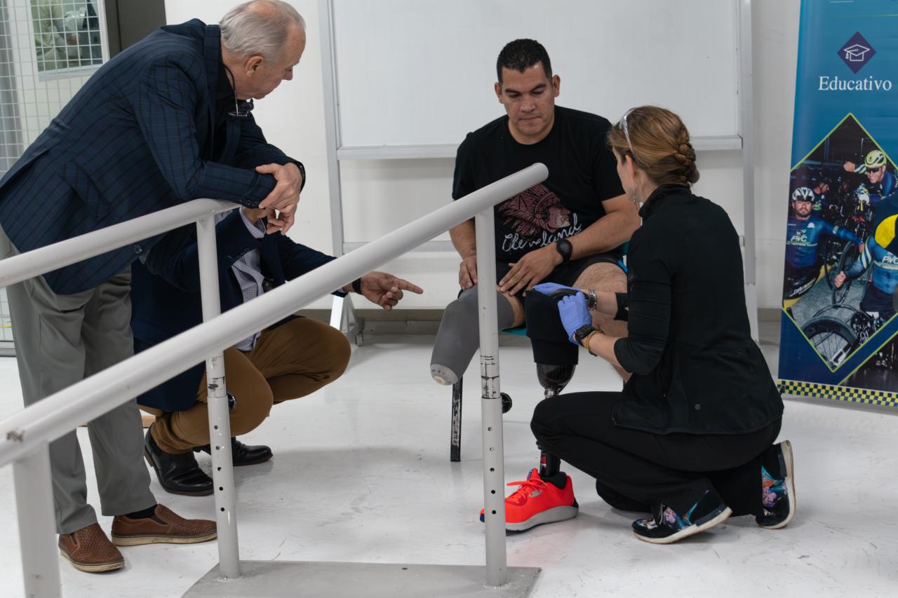 Michael Lundquist and Nellie Zarif in Colombia with a man who uses a prosthetic leg. 