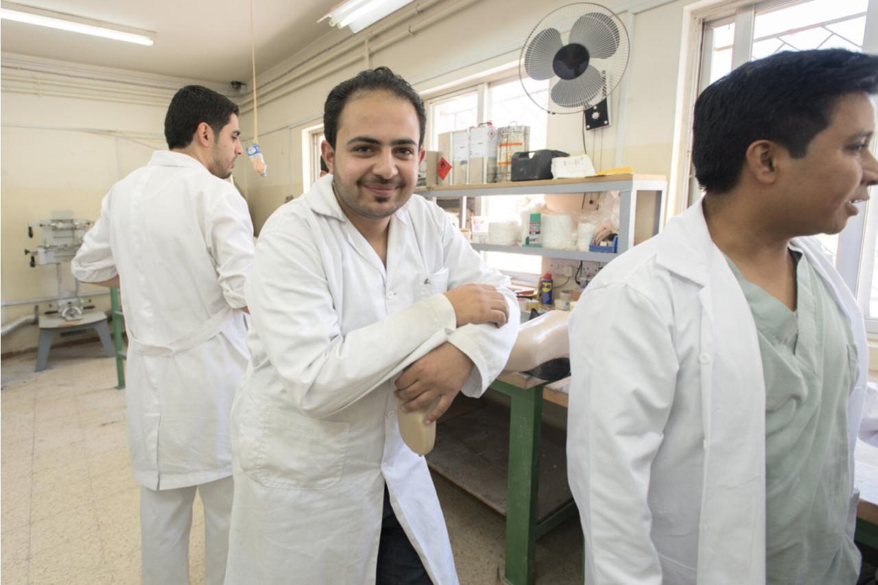 Three prosthetic technicians at workshop in Jordan.