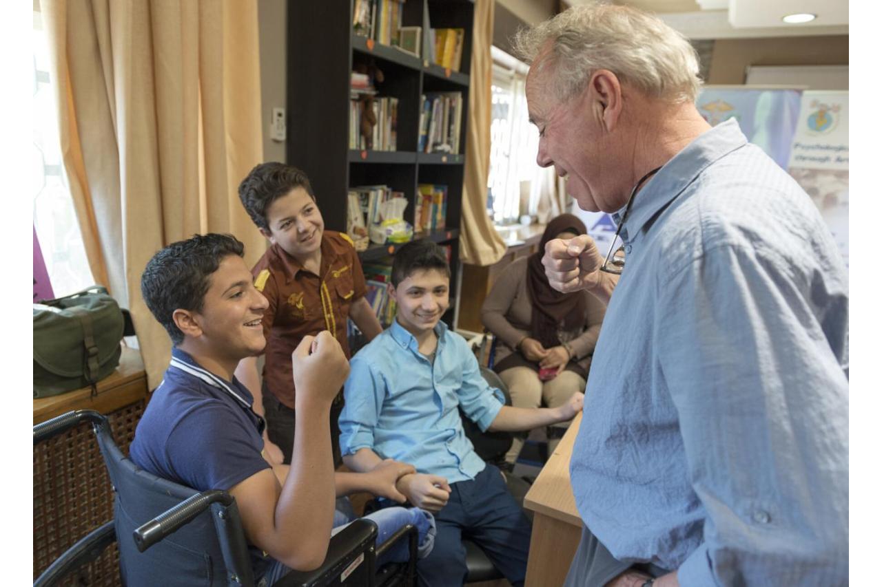 Man interacting with children at rehabiliation center in Amman, Jordan.