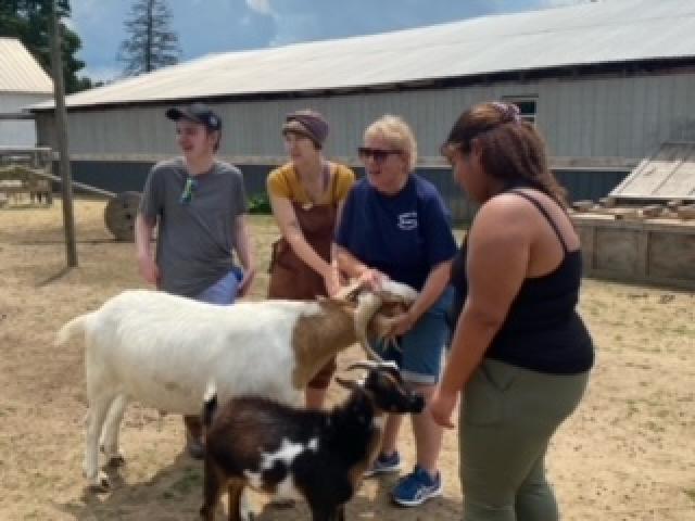 ESP students gather around a goat