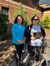 Katie Crocker holds her award with Executive Director Theresa Kane 