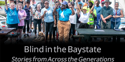 Group photo on the bay of blind individuals alongside staff