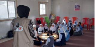 A teacher leading an expressive arts class in Mosul, Iraq. 